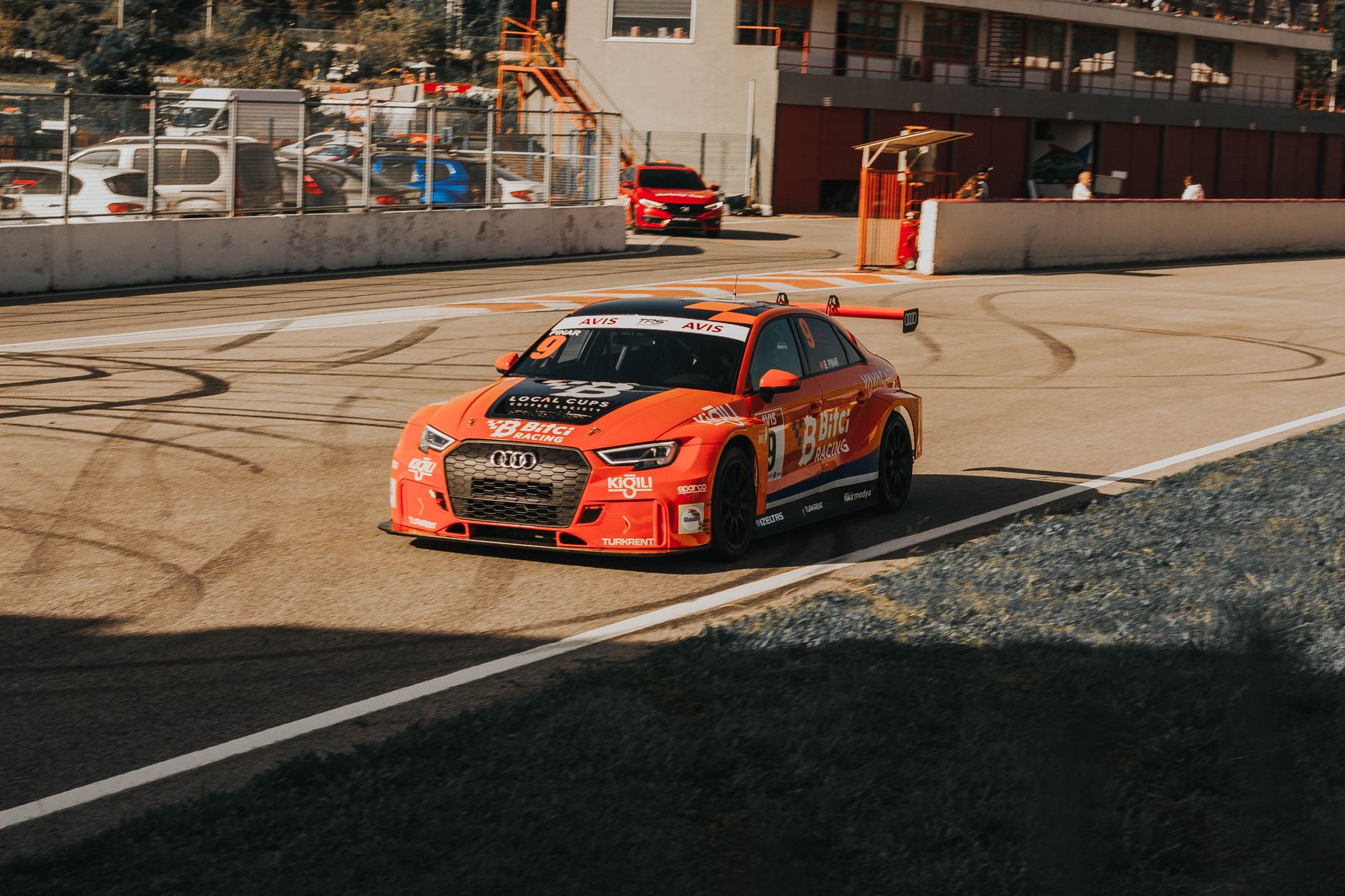 Audi RS 3 racecar on a sunny day at a Turkish racetrack showing speed and performance.